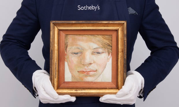 A Sotheby's handler holds Head of a Boy (1956) by Lucian Freud. Image courtesy of Sotheby's