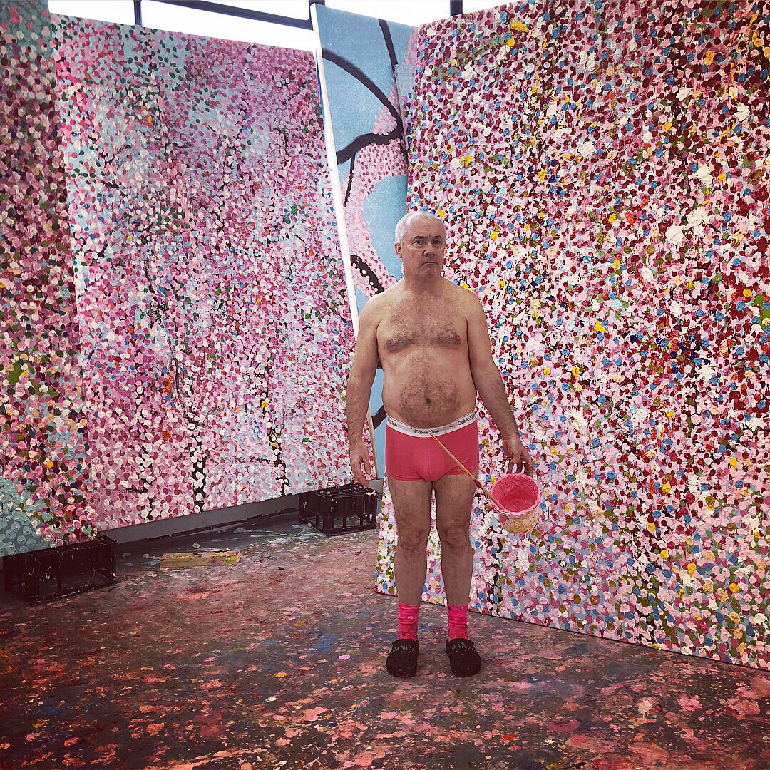 Damien Hirst with his veil paintings. Image courtesy of Hirst's Instagram