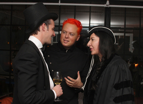 Marina Abramović (right) speaks to guests including Jamie Prentice (left) and John Kluge Jr. (middle) at her Halloween party on Monday night