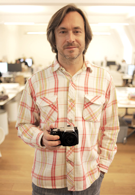 Marc Newson holding the Pentax K-01