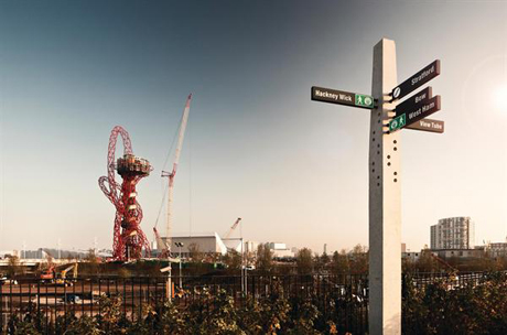 Photograph of the <em>Orbit Tower</em> rising over London's East End (Photography by Dylan Collard)
