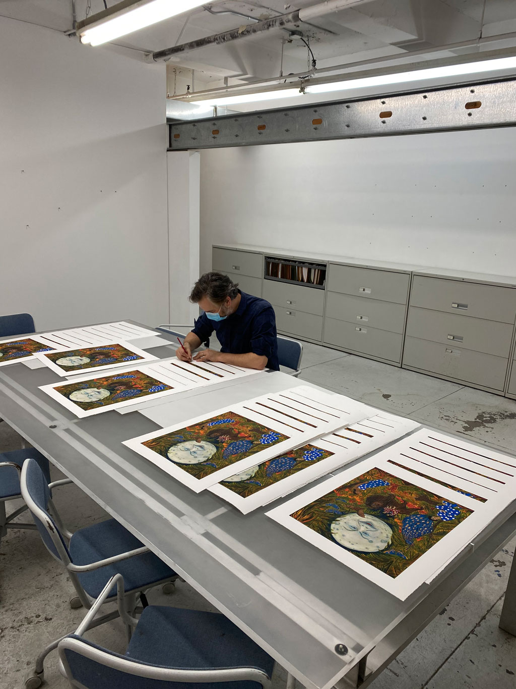 Marcel Dzama signing his Artspace/ RxART limited edition The Illumination of the sisters of paradise, 2020 at Lower East Side Printshop, October 2020