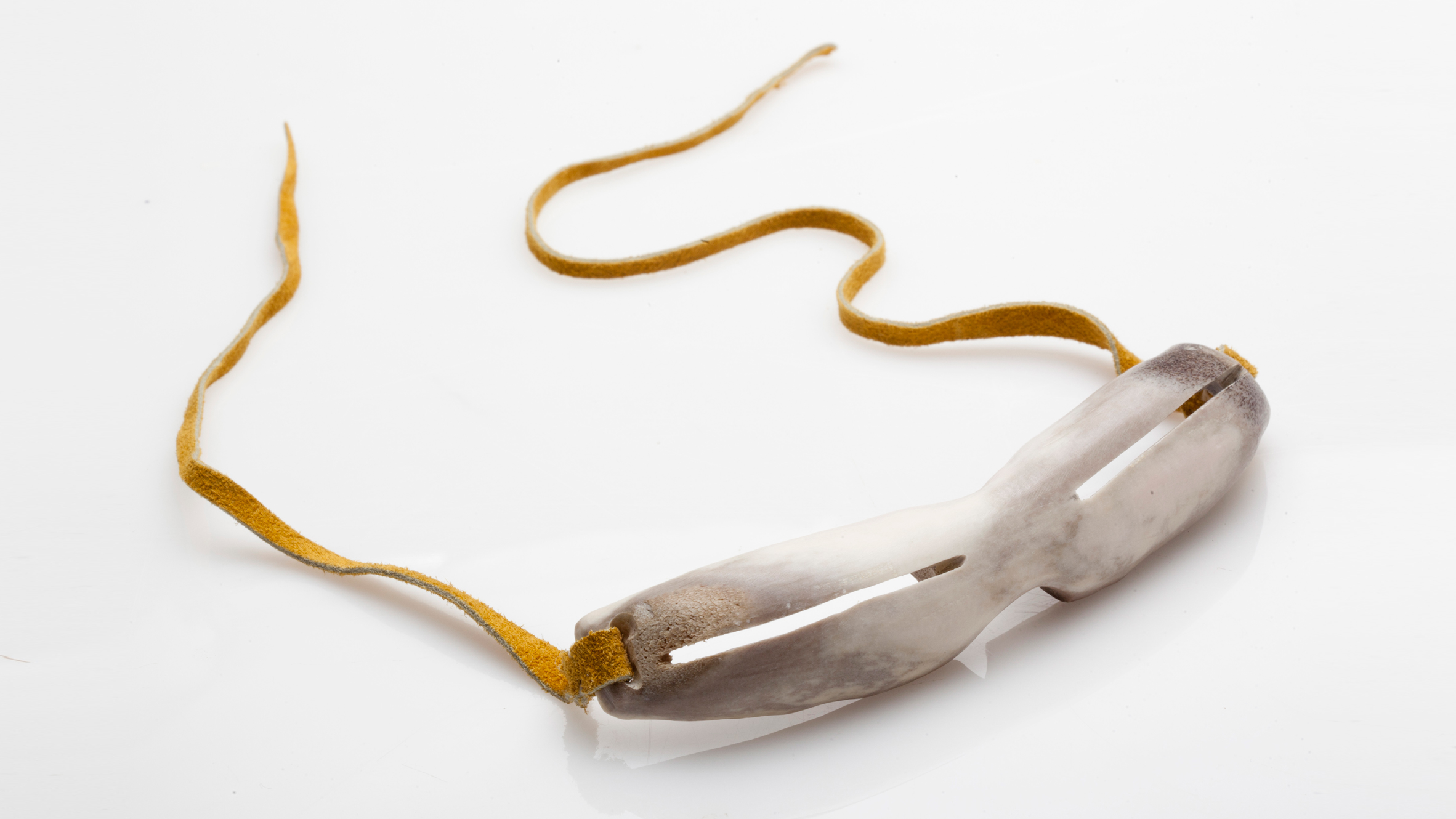 A pair of Inuit snow goggles fashioned from bone. Image courtesy of Design Museum Holon