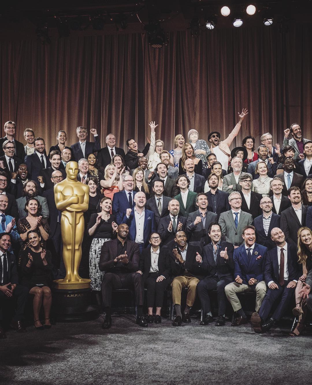 JR and his Varda cut-out at the Oscar Nominees luncheon group photograph. Photo by Marc Azoulay, image courtesy of JR's Instagram 