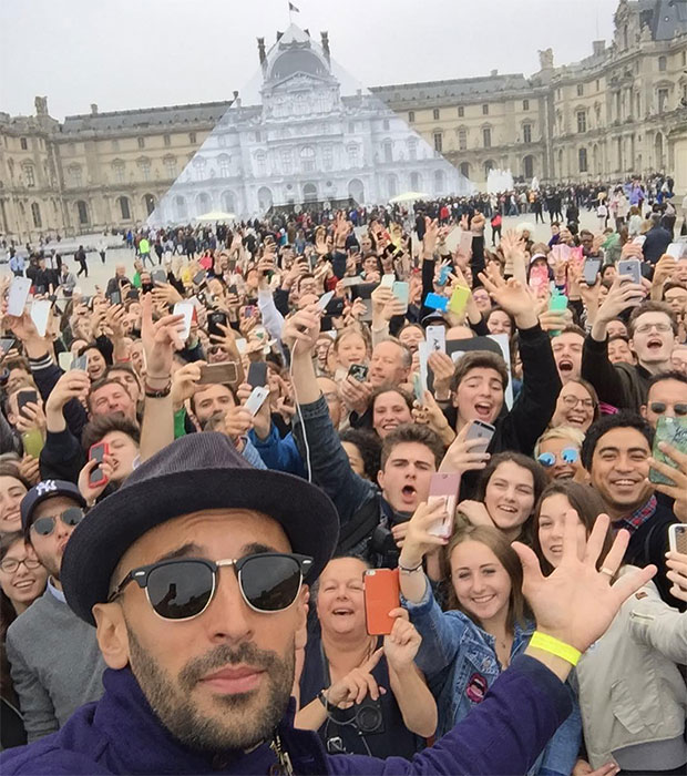 JR and fans outside the Louvre, Paris