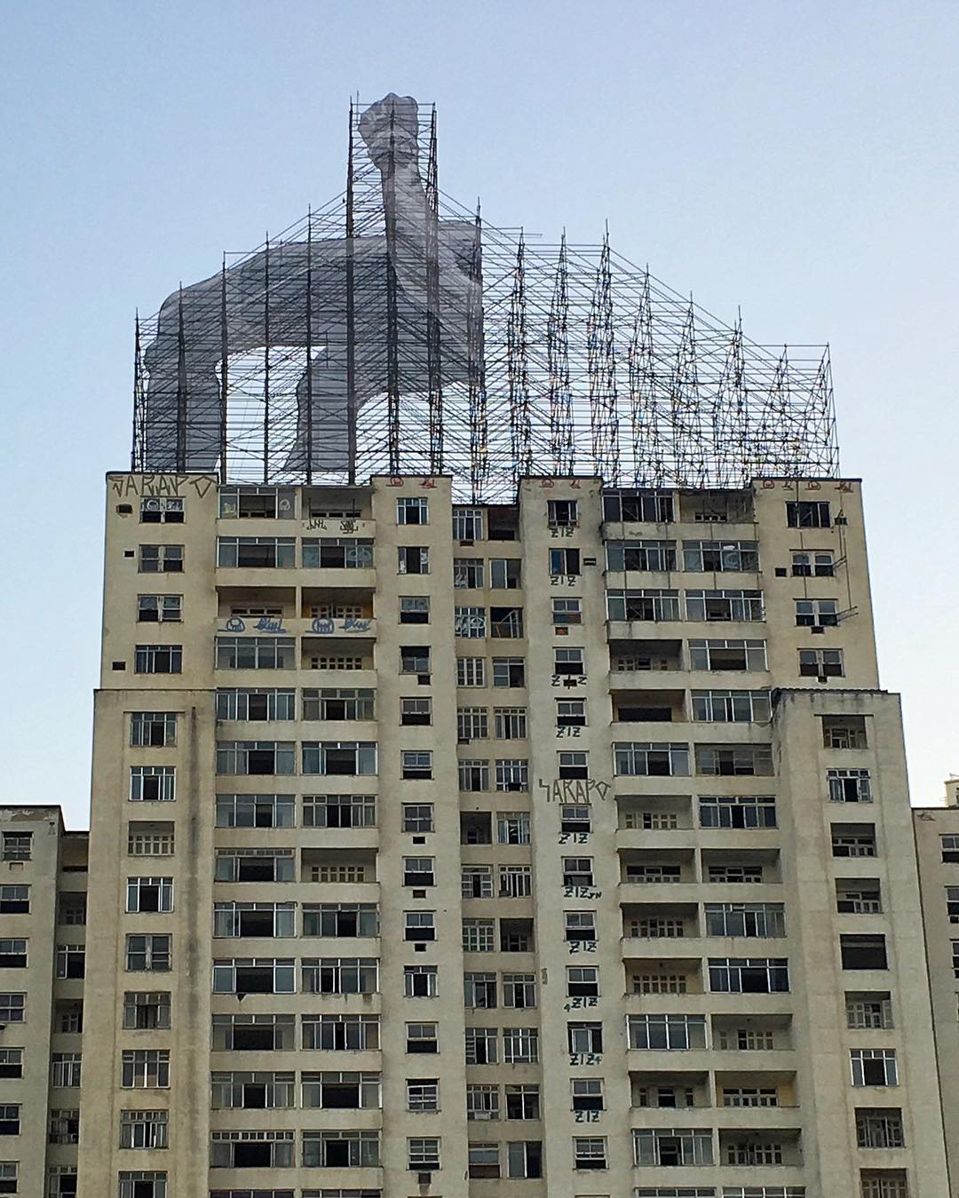 JR and his team install a new piece in Rio. Image courtesy of the artist's Instagram