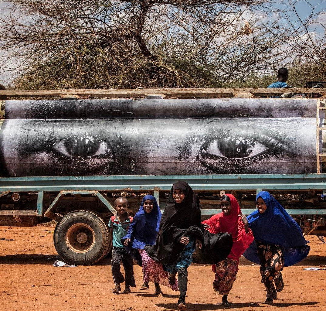 JR paste-up eye photos (taken by Yasin Osman) on the side of a a relief truck in Somalia. Image courtesy of JR's Instagram