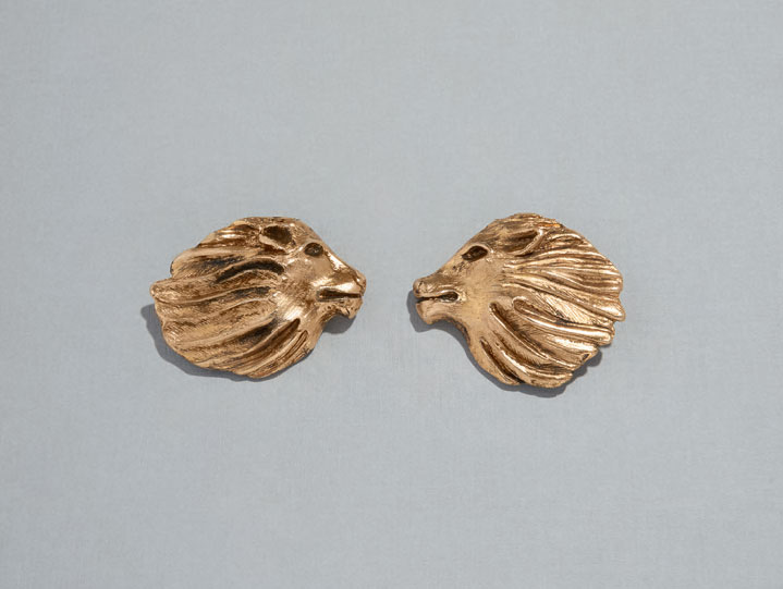 Gilt metal earrings in the shape of lions’ heads in profile, Autumn/Winter 1986 haute couture collection. All images from Yves Saint Laurent Accessories
