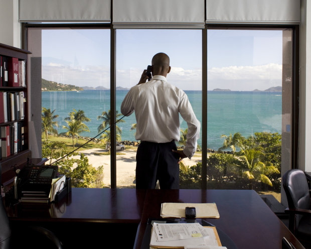 Neil Smith, financial secretary of the British Virgin Islands, in his office in Road Town, Tortola. From The Heavens, Annual Report by Paolo Woods and Gabriele Galimberti