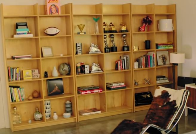 Lizzo's award shelf, which also displays her Rihanna book (center column, second from the bottom)
