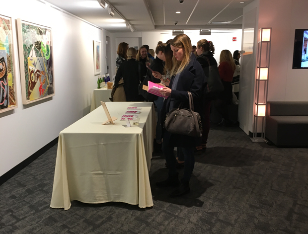 Guests look at Magnus's book Management of Art Galleries