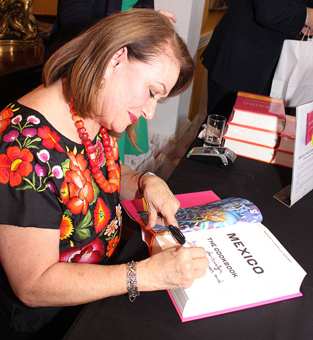 Margarita signs books for the ambassador's guests