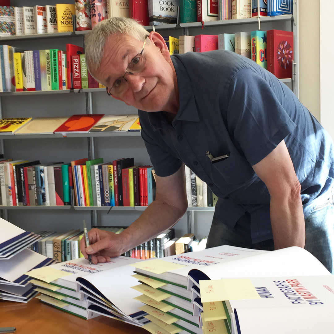 Martin Parr signing copies of his book in Phaidon's London office. These ones are available to buy here
