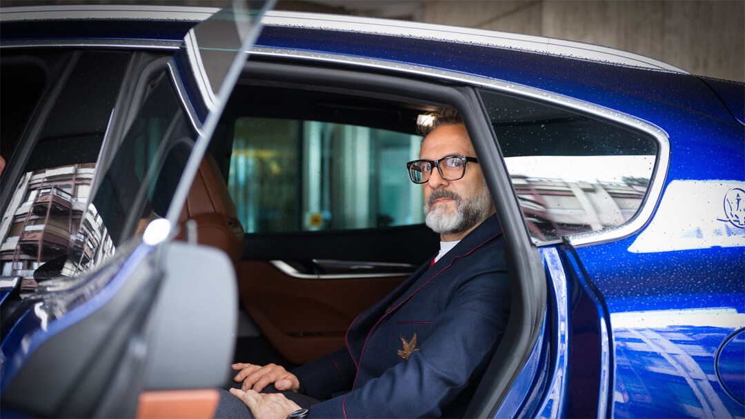 Massimo Bottura in a Maserati at the Geneva motor show. Image courtesy of Maserati