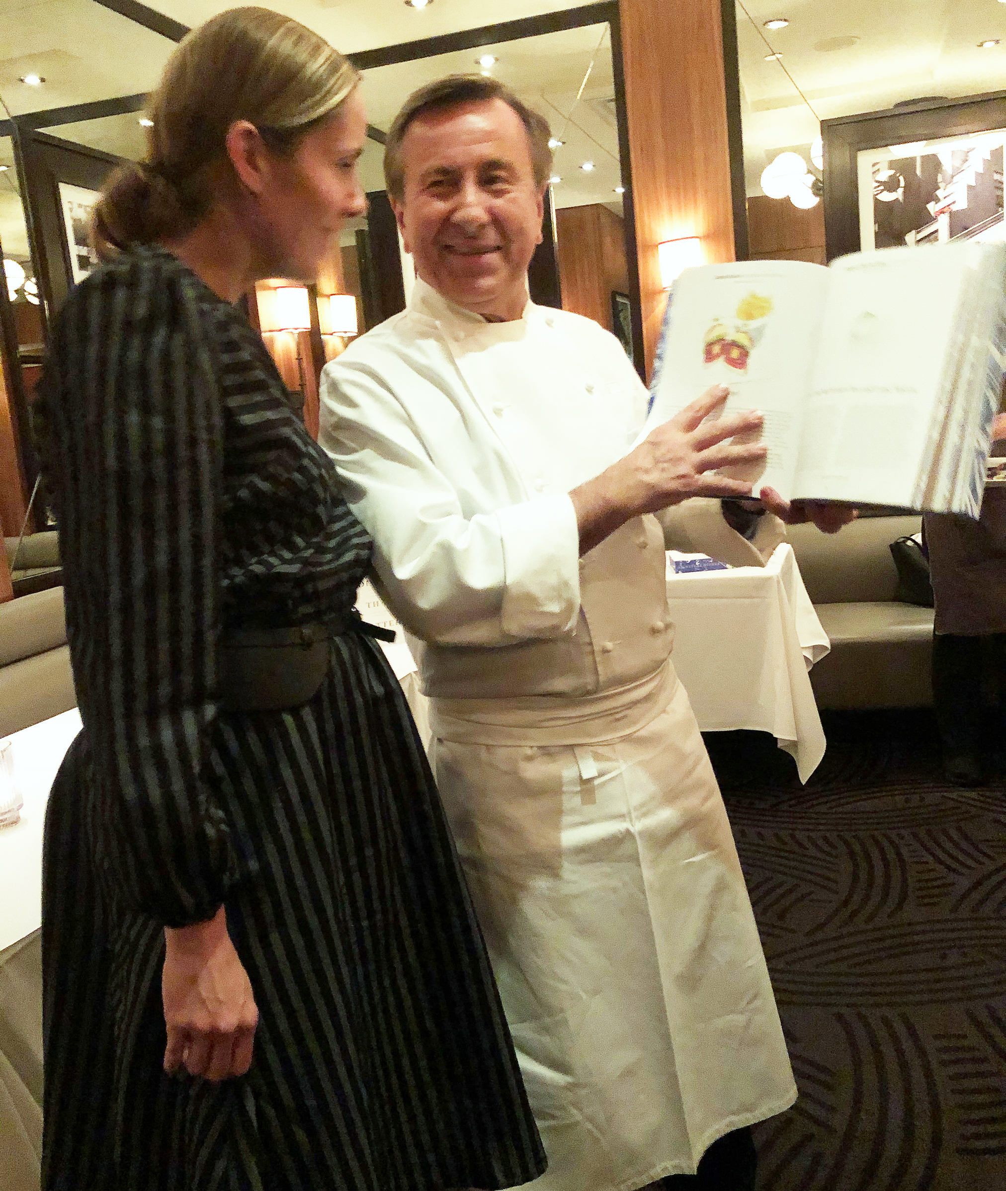 Chef Daniel Boulud with a copy of Signature Dishes that Matter