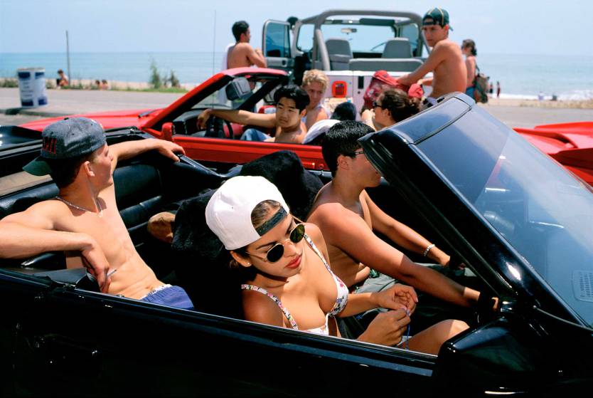 Mijanou, 18, who was voted Best Physique at Beverly Hills High School, skips class to go to the beach with friends on the annual Senior Beach Day, Santa Monica, California, 1993. From Generation Wealth by Lauren Greenfield