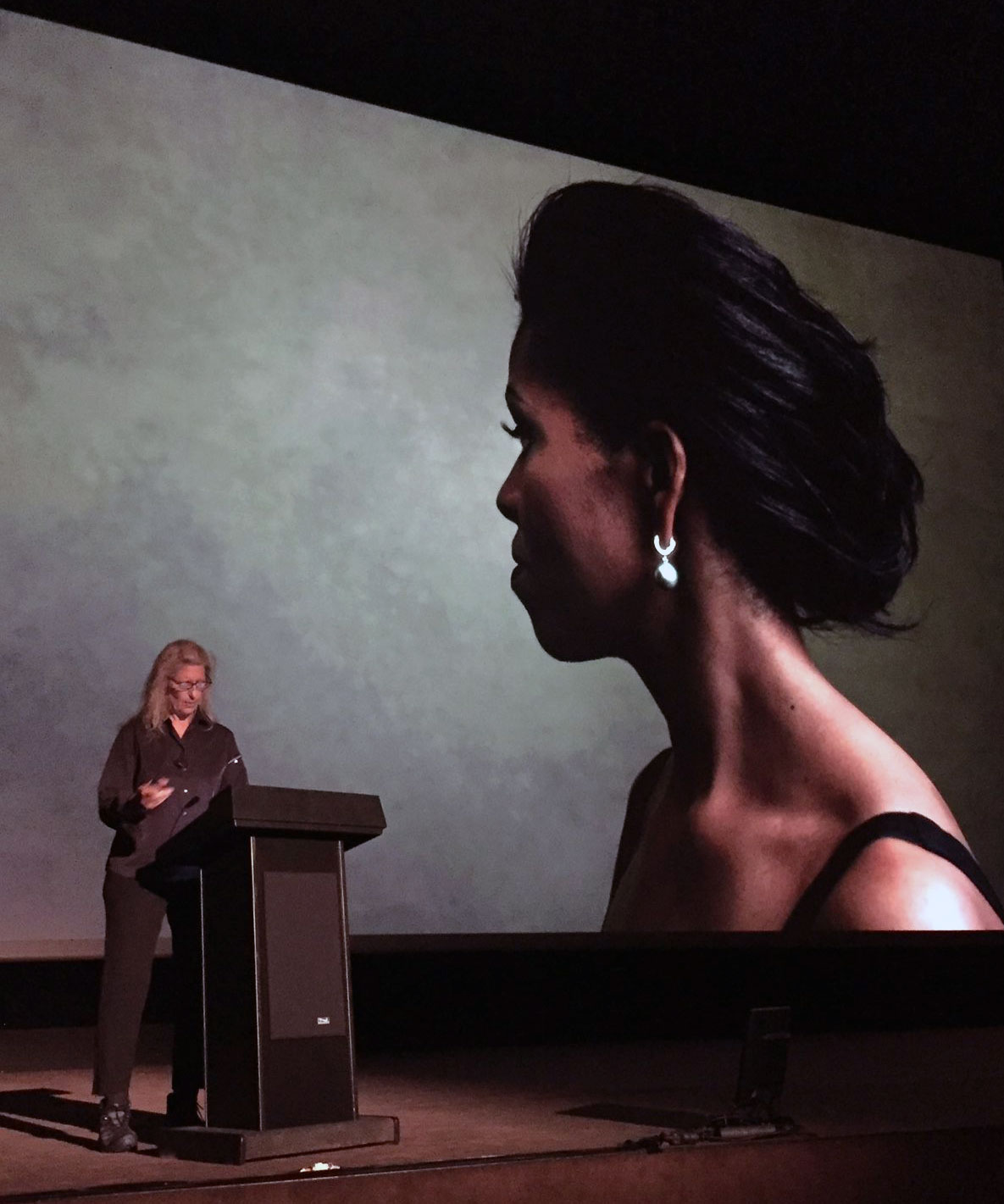 Annie Leibovitz beside her 2012 portrait of Michelle Obama, at the MK2 Cinema in Paris