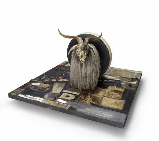 Monogram (1955-59) Combine: oil, paper, fabric, printed reproductions, metal, wood, rubber shoe-heel, and tennis ball on two conjoined canvases with oil on taxidermied Angora goat with brass plaque and rubber tire on wood platform mounted on four casters 106.7 x 135.2 x 163.8 cm Moderna Museet, Stockholm. Purchase with contribution from Moderna Museets Vänner/The Friends of Moderna Museet © Robert Rauschenberg Foundation, New York. Image courtesy of the Tate