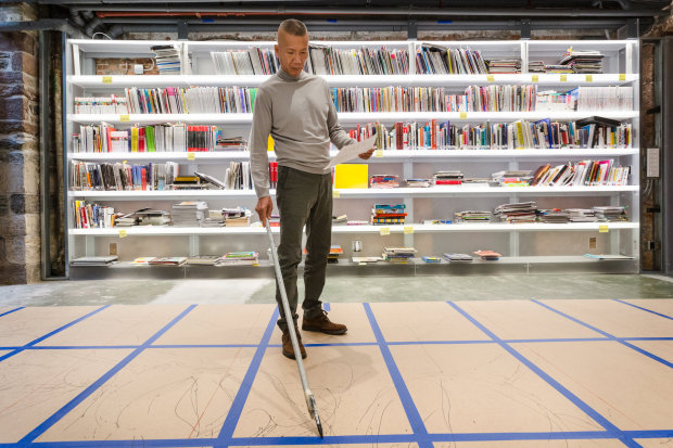 Cai Guo-Qiang in his new studio's library, by OMA. Photo by Brett Beyer, brettbeyerphotography.com 