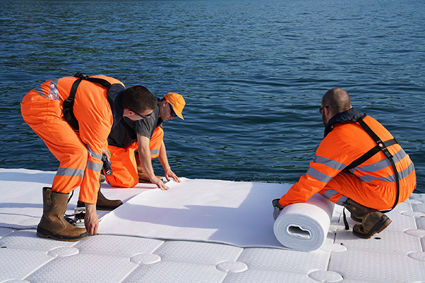 Workers install the felt that will cover the floating cubes before the yellow fabric is installed, May 2016 Photo: Wolfgang Volz