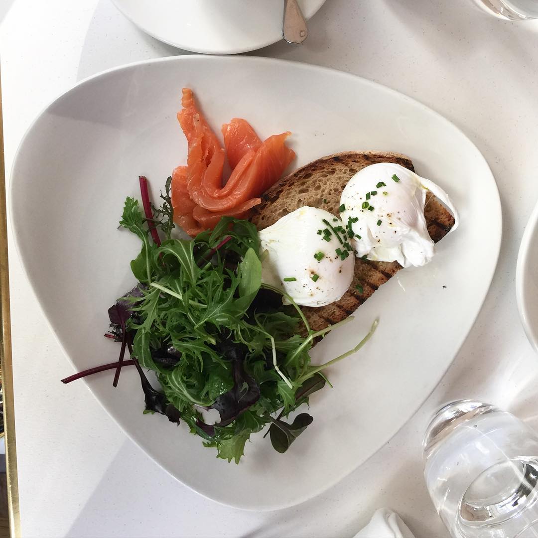 Poached eggs, smoked salmon, sourdough bread, and a sprinkling of fresh herbs. Image courtesy of Eve O'Sullivan's Instagram (eve_osullivan)