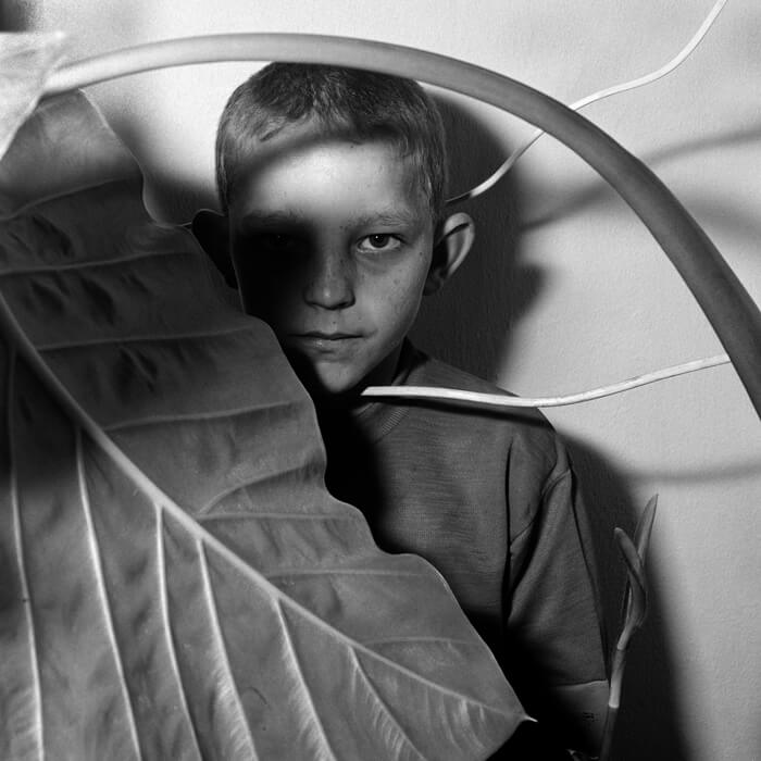 Study of Boy and Plant 1999 Outland 40x40 cm Gelatin silver print Copyright Roger Ballen