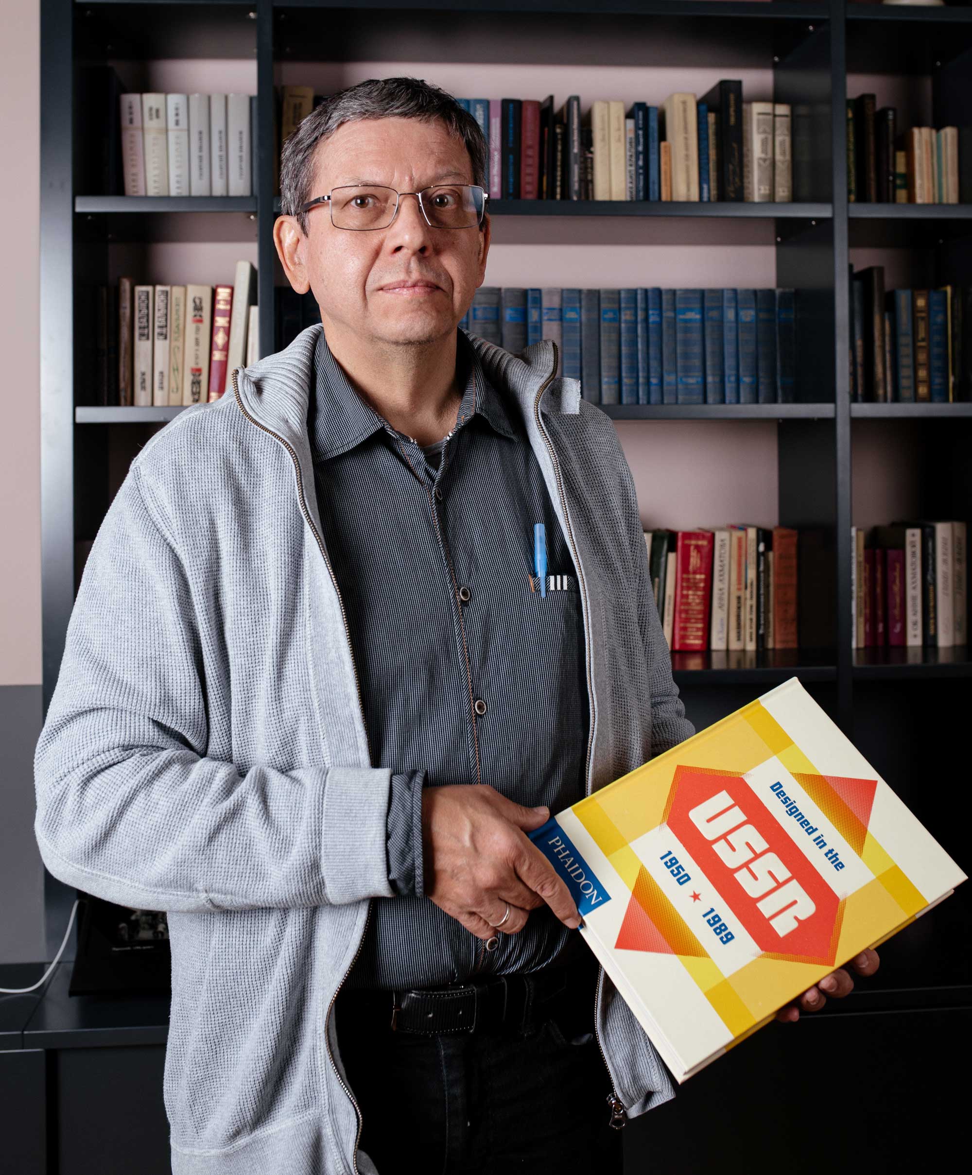 Alexander Lavrentyev, one of the designers featured in Designed in the USSR: 1950-1989 holding a copy of the book photographed at the Tretiakov Gallery in Moscow last month