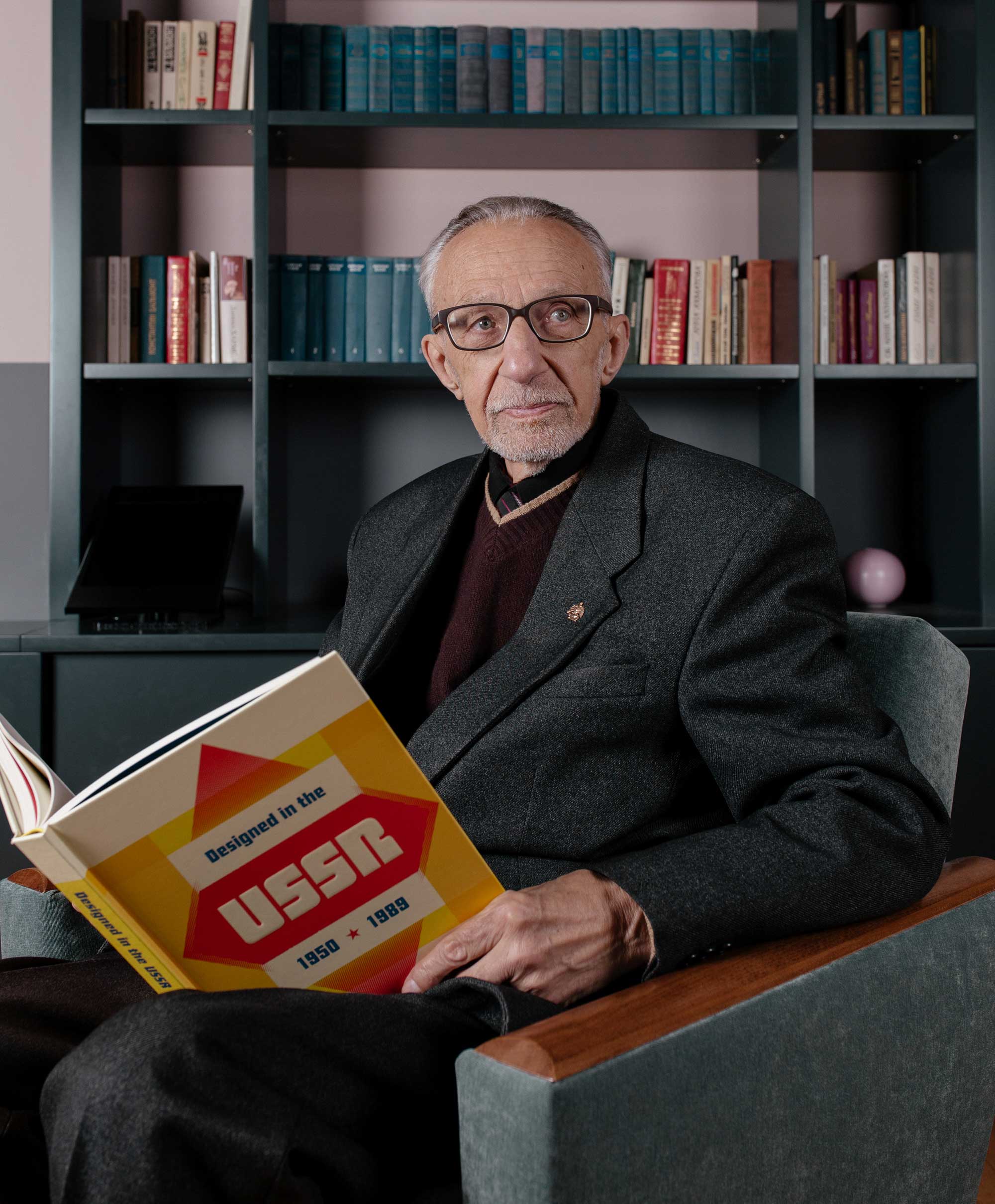 Vladimir Runge, one of the designers featured in Designed in the USSR: 1950-1989 holding a copy of the book photographed at the Tretiakov Gallery in Moscow last month