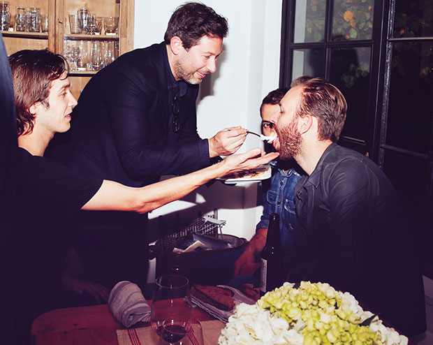 Thomas Carter, co-owner of New York's Estela restaurant feeds chef Mads Refslund at Adam Sachs’ Brooklyn house. Photograph by Michelle Heimerman