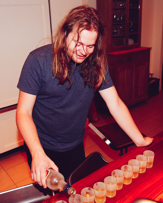 Magnus pours aquavit shots at Adam Sachs’ Brooklyn house. Photograph by Michelle Heimerman