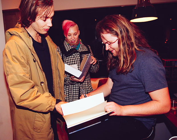 Magnus signs books for fellow chefs Fredrik Berselius and Emma Bengtsson at Adam Sachs’ Brooklyn house. Photograph by Michelle Heimerman