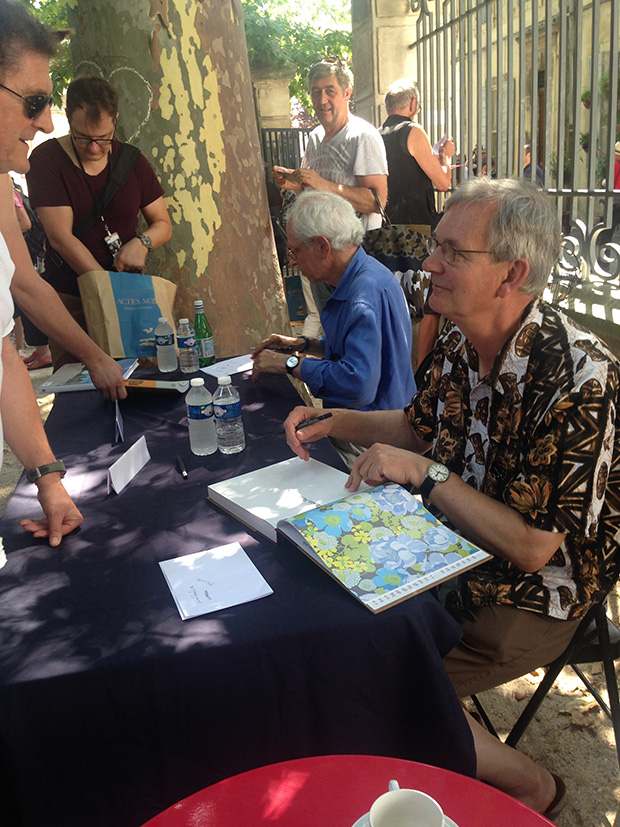 Stephen Shore and Martin Parr sign books at the Rencontres d'Arles. Martin is signing a copy of our monograph