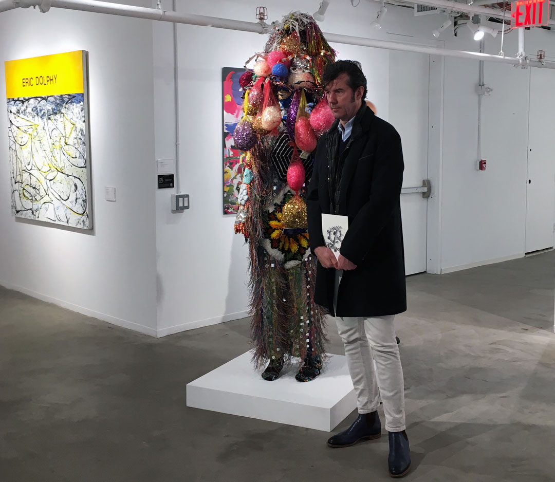 Stefan Sagmeister with Nick Cave's Soundsuit, 2006, now on view at Phillips New York
