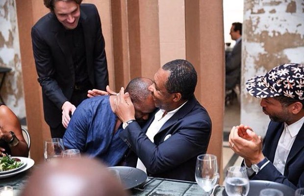 From right: Ken Stewart, Rebuild’s CEO, looks on as Okwui Enwezor embraces Theaster Gates at a dinner to celebrate Gates’ newly restored Stony Island Arts Bank, Chicago. Image from Rebuild’s Instagram, taken by Kelly Taub, for BFA partnerships