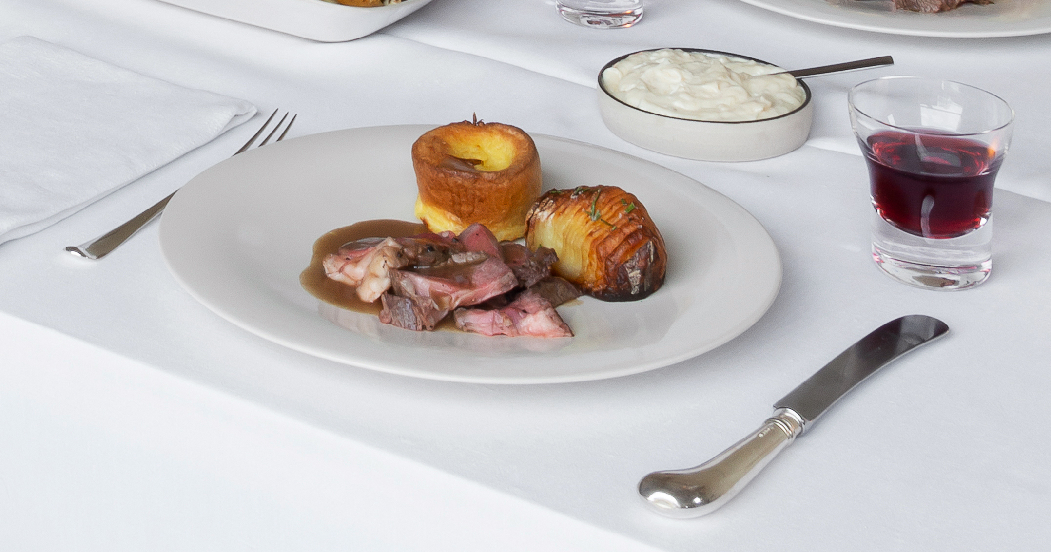 Roast rib of beef with Yorkshire puddings and horseradish sauce. Photography by Gilbert McCarragher