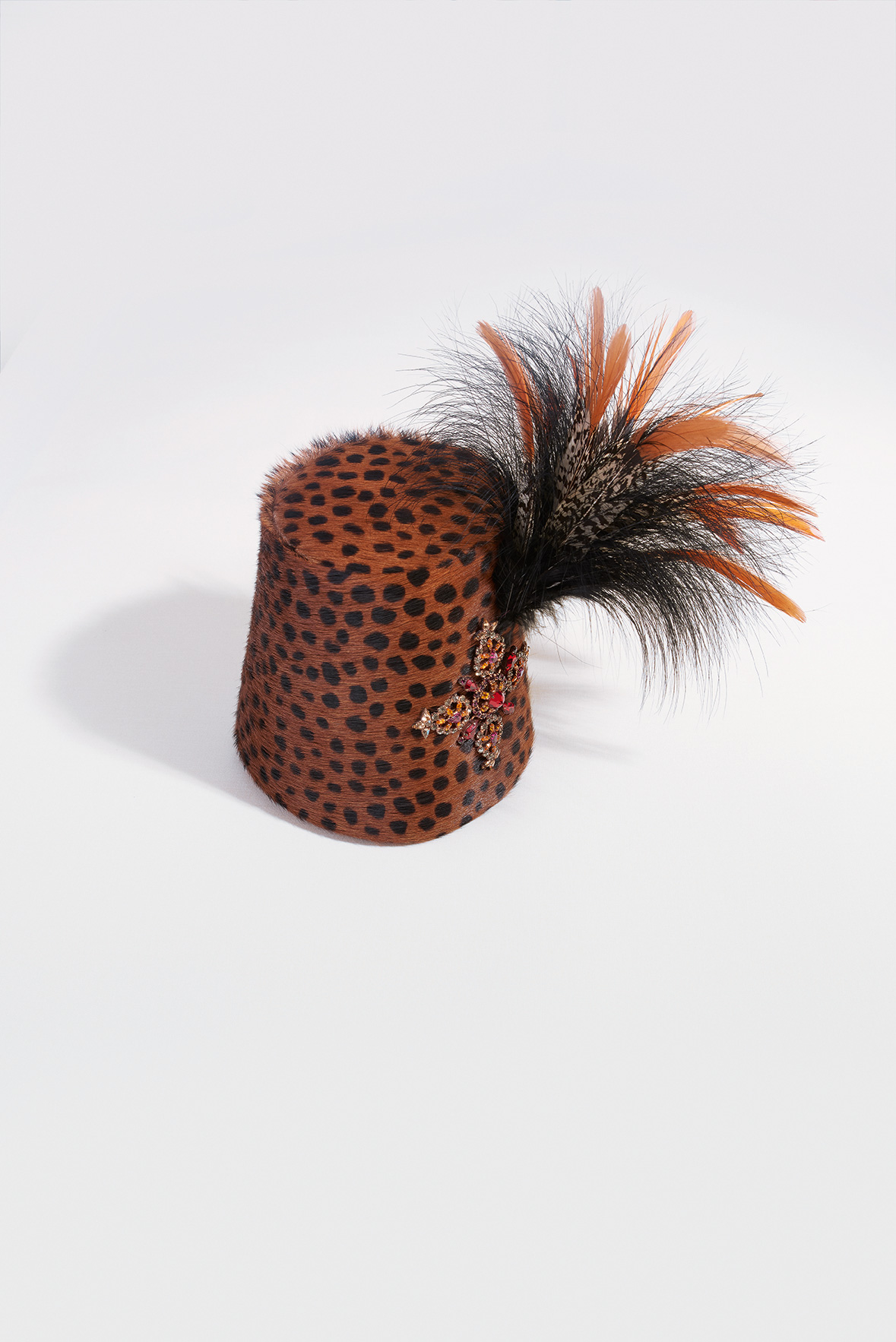 Fez made of printed foal leather with feathers pinned in place by a multicoloured diamanté brooch (made by Sabbagh), Autumn/Winter 1992 haute couture collection